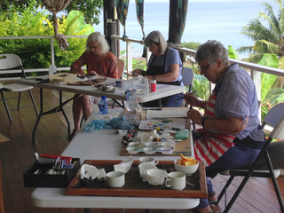 Students participate in a painting workshop on the deck at Daku Resort, Savusavu.