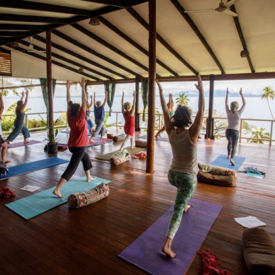 Brett Monroe Garner leads yoga on the deck at Daku Resort, Savusavu.